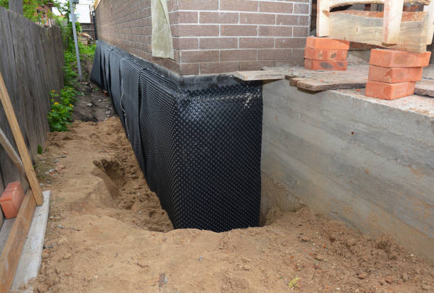 Happy homeowners after waterproofing job in Hudson